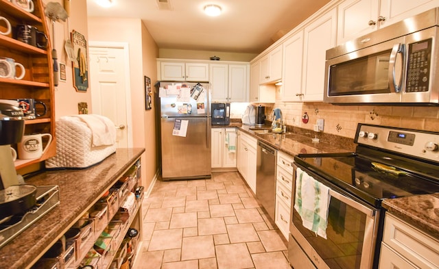 61626 Colony Bay Dr Unit 15, Cassopolis, MI 49031 - kitchen featuring appliances with stainless steel finishes, tasteful backsplash, white cabinetry, and dark stone counters