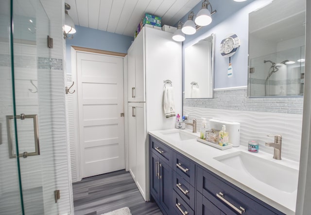61626 Colony Bay Dr Unit 15, Cassopolis, MI 49031 - full bathroom with double vanity, a shower stall, wood finished floors, and decorative backsplash