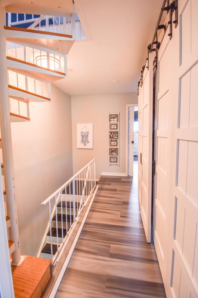 61626 Colony Bay Dr Unit 15, Cassopolis, MI 49031 - corridor featuring wood finished floors, a barn door, and stairs