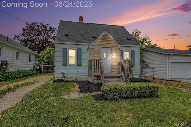 2061 E Boatfield Ave, Burton, MI 48529 - view of front facade featuring a chimney, a yard, roof with shingles, and a garage