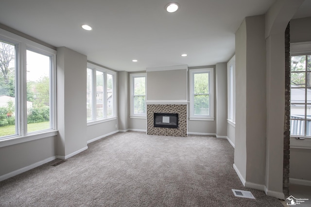 901 Chicago Blvd, Detroit, MI 48202 - unfurnished living room featuring plenty of natural light, carpet, recessed lighting, and a tile fireplace