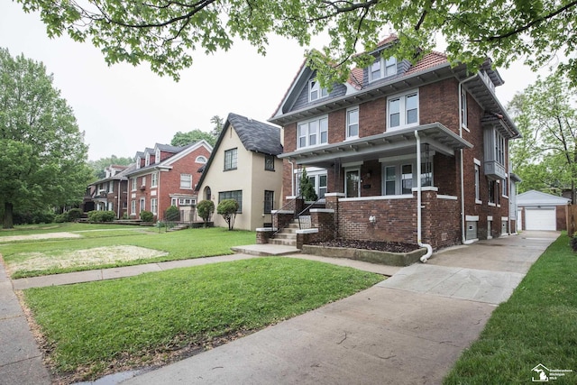901 Chicago Blvd, Detroit, MI 48202 - view of front facade with a porch, brick siding, a front yard, an outbuilding, and a detached garage