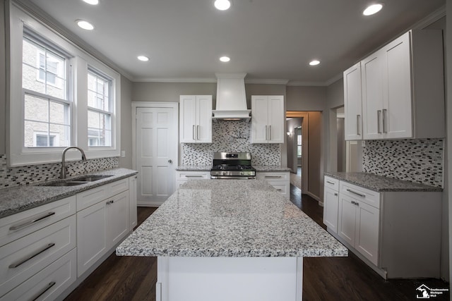901 Chicago Blvd, Detroit, MI 48202 - kitchen featuring gas stove, custom range hood, ornamental molding, decorative backsplash, and dark wood-type flooring