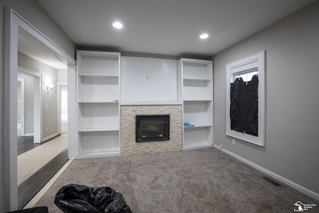 901 Chicago Blvd, Detroit, MI 48202 - unfurnished living room featuring a stone fireplace, carpet flooring, recessed lighting, and built in shelves