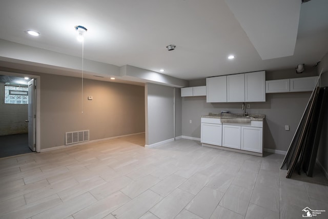 901 Chicago Blvd, Detroit, MI 48202 - kitchen featuring white cabinetry, recessed lighting, and light stone counters