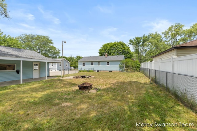 1372 Brookmark St SE, Kentwood, MI 49508 - fenced backyard with a fire pit