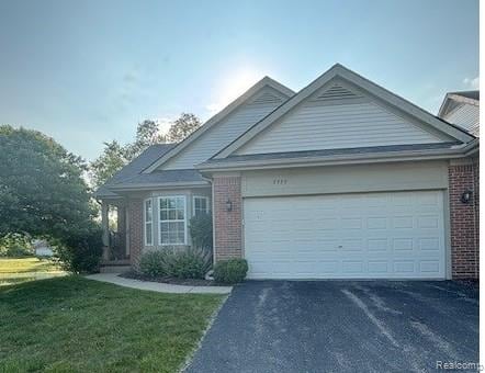 5959 Augusta Ln Unit 20, Grand Blanc, MI 48439 - ranch-style home with brick siding, asphalt driveway, a garage, and a front yard
