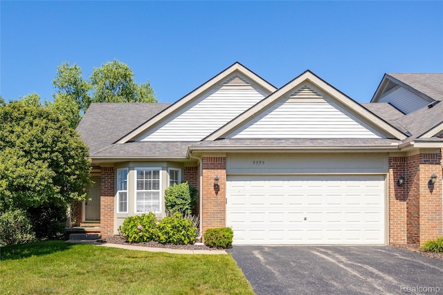 5959 Augusta Ln Unit 20, Grand Blanc, MI 48439 - view of front of home with brick siding, an attached garage, driveway, a front lawn, and a shingled roof