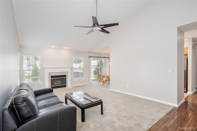 5959 Augusta Ln Unit 20, Grand Blanc, MI 48439 - living area with high vaulted ceiling, a ceiling fan, a premium fireplace, and light wood-style flooring