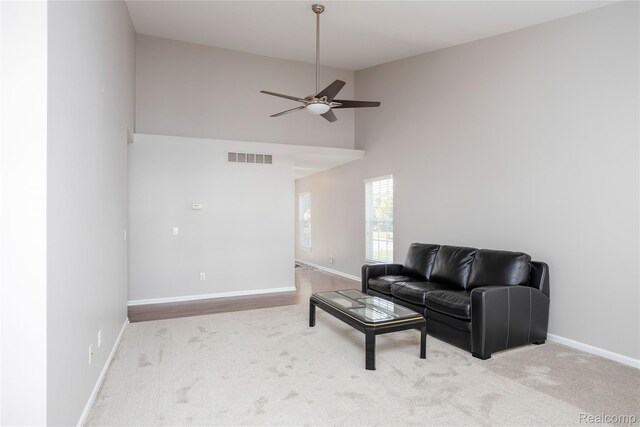 5959 Augusta Ln Unit 20, Grand Blanc, MI 48439 - carpeted living area with a ceiling fan and a high ceiling