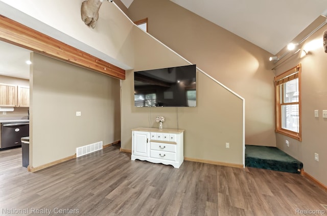1471 Eldon Ct, Gladwin, MI 48624 - unfurnished living room featuring wood finished floors and vaulted ceiling