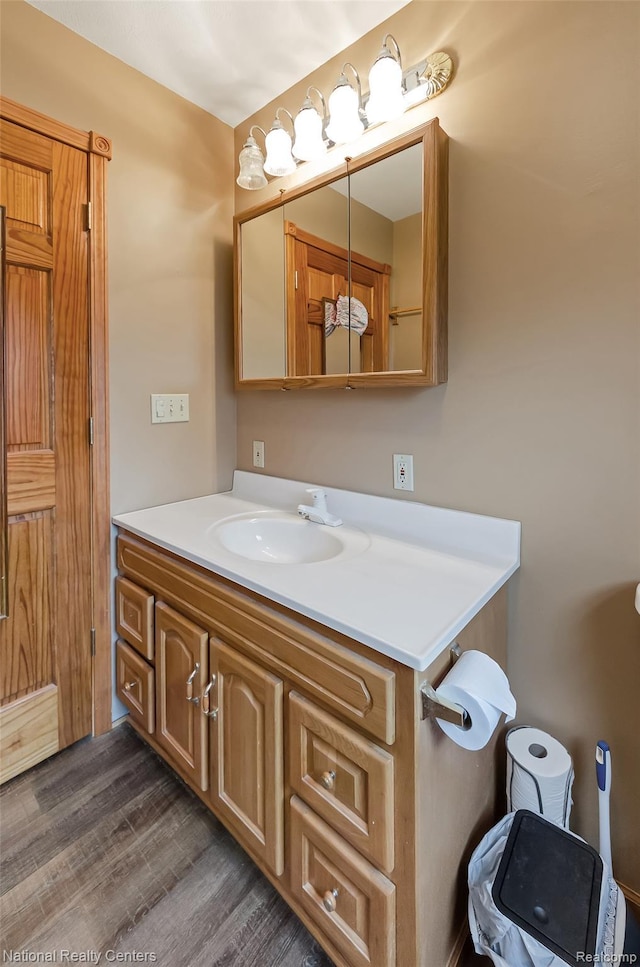 1471 Eldon Ct, Gladwin, MI 48624 - bathroom with vanity and wood finished floors