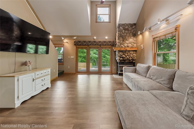 1471 Eldon Ct, Gladwin, MI 48624 - living room with high vaulted ceiling, wood finished floors, and a fireplace