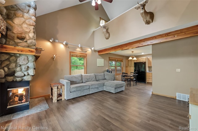 1471 Eldon Ct, Gladwin, MI 48624 - living area with ceiling fan, dark wood finished floors, a fireplace, and high vaulted ceiling