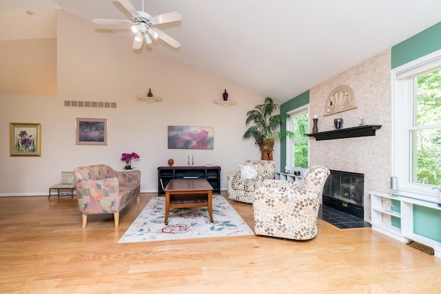 3105 Earlmoore Ln, Ann Arbor, MI 48105 - living room featuring wood finished floors, a ceiling fan, a large fireplace, and high vaulted ceiling