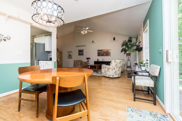 3105 Earlmoore Ln, Ann Arbor, MI 48105 - dining space with ceiling fan, light wood-style flooring, a chandelier, and high vaulted ceiling