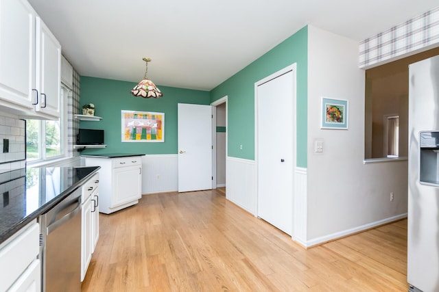 3105 Earlmoore Ln, Ann Arbor, MI 48105 - kitchen featuring stainless steel dishwasher, dark countertops, white refrigerator with ice dispenser, light wood finished floors, and white cabinets
