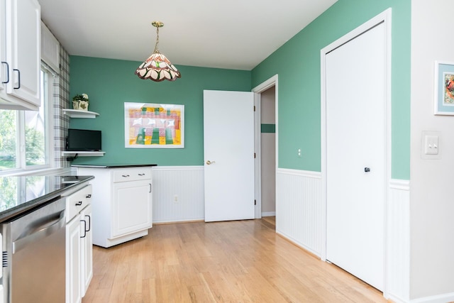3105 Earlmoore Ln, Ann Arbor, MI 48105 - kitchen with stainless steel dishwasher, wainscoting, light wood finished floors, white cabinetry, and dark countertops
