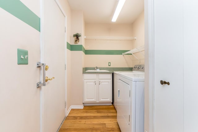 3105 Earlmoore Ln, Ann Arbor, MI 48105 - washroom with light wood finished floors, washing machine and dryer, and cabinet space