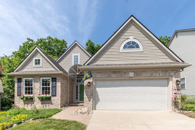 3105 Earlmoore Ln, Ann Arbor, MI 48105 - view of front of property featuring driveway, a garage, and brick siding
