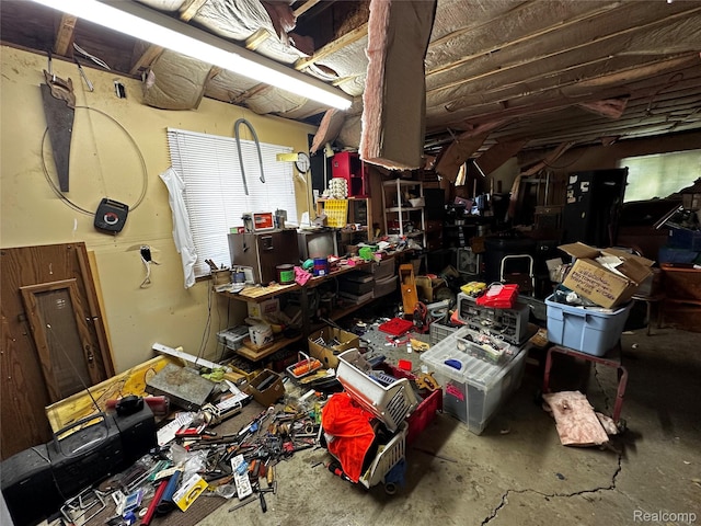 12910 Wilbur Rd, Clinton, MI 49236 - miscellaneous room featuring unfinished concrete flooring and a workshop area
