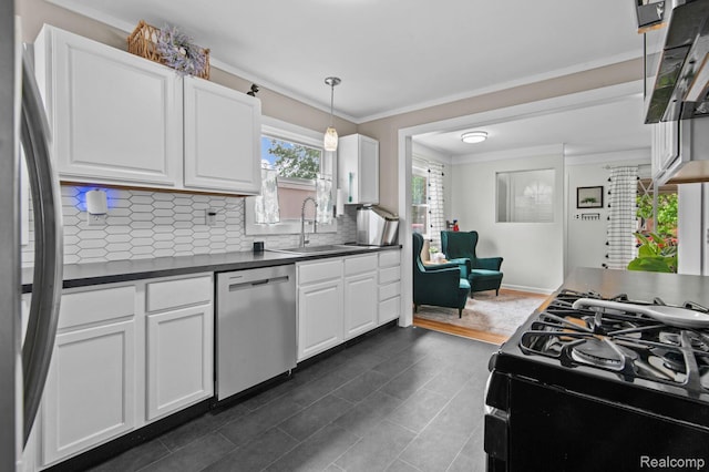 29948 Hathaway St, Livonia, MI 48150 - kitchen featuring appliances with stainless steel finishes, dark countertops, backsplash, ornamental molding, and white cabinets