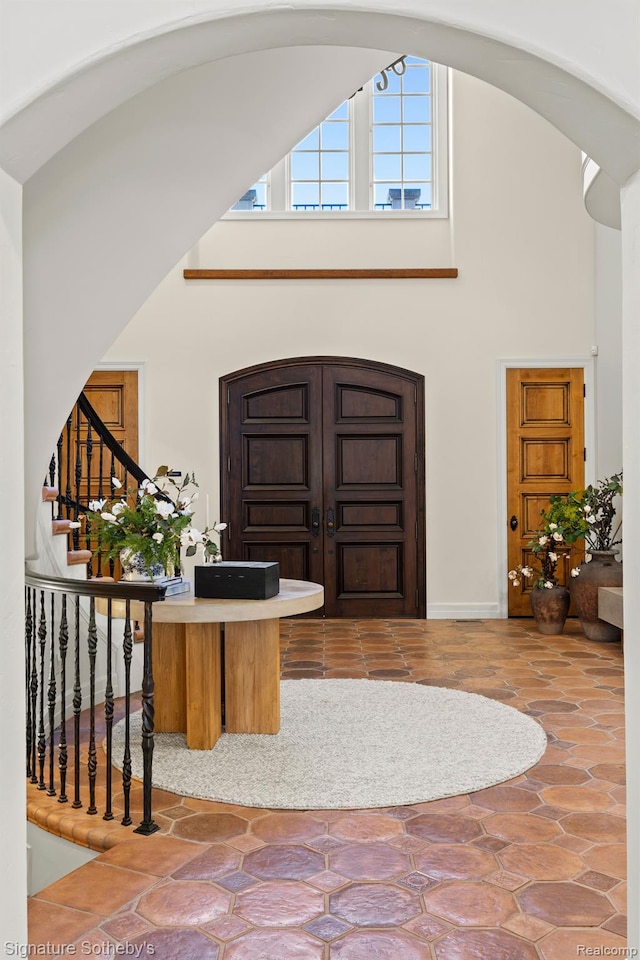597 Yarboro Dr, Bloomfield Hills, MI 48304 - entryway with high vaulted ceiling, stairs, and arched walkways