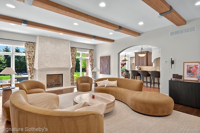 597 Yarboro Dr, Bloomfield Hills, MI 48304 - living area featuring arched walkways, wood finished floors, beamed ceiling, a premium fireplace, and recessed lighting