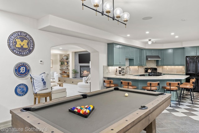 597 Yarboro Dr, Bloomfield Hills, MI 48304 - rec room with arched walkways, a glass covered fireplace, billiards table, recessed lighting, and light floors