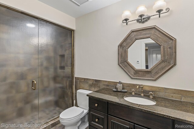 597 Yarboro Dr, Bloomfield Hills, MI 48304 - full bathroom featuring vanity, tile walls, a stall shower, and wainscoting
