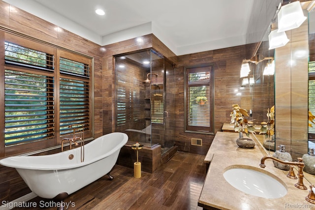 597 Yarboro Dr, Bloomfield Hills, MI 48304 - full bath with a freestanding tub, vanity, wood finished floors, a shower, and wooden walls
