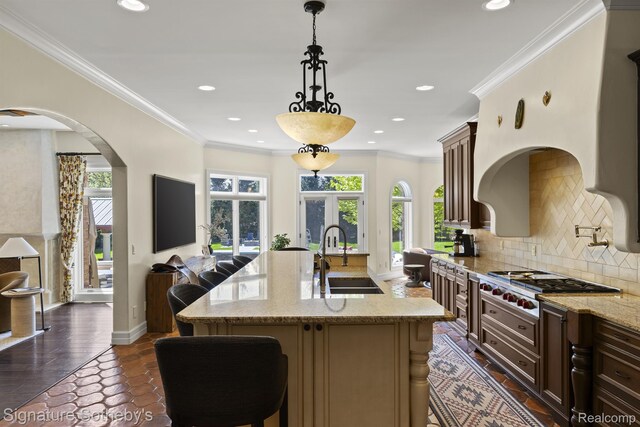 597 Yarboro Dr, Bloomfield Hills, MI 48304 - kitchen with stainless steel gas stovetop, healthy amount of natural light, decorative backsplash, light stone countertops, and recessed lighting