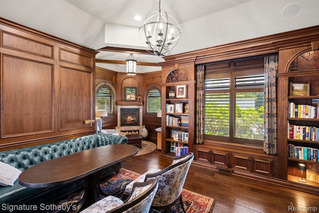 597 Yarboro Dr, Bloomfield Hills, MI 48304 - home office featuring a chandelier, dark wood finished floors, a warm lit fireplace, and a towering ceiling
