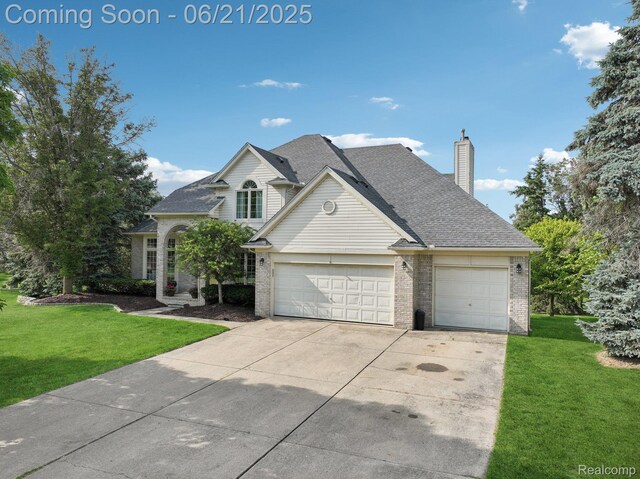 21898 Aspen Ct, Farmington Hills, MI 48335 - traditional-style house with brick siding, driveway, an attached garage, and a front yard