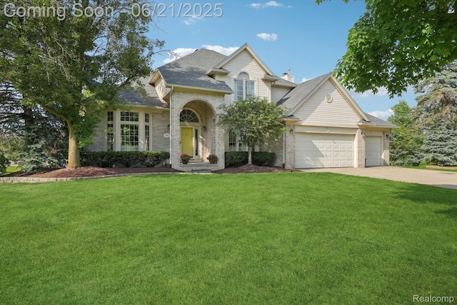 21898 Aspen Ct, Farmington Hills, MI 48335 - traditional-style home with brick siding, a front lawn, a garage, and driveway