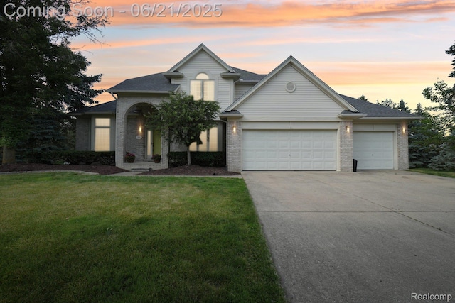 21898 Aspen Ct, Farmington Hills, MI 48335 - traditional home with brick siding, an attached garage, concrete driveway, and a lawn