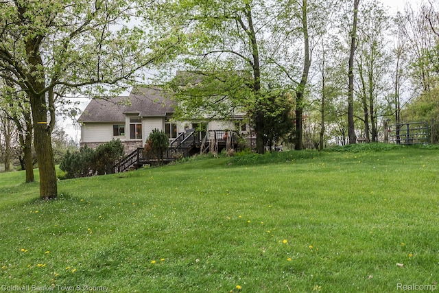 1355 Maxfield Rd, Brighton, MI 48114 - view of grassy yard with a deck and stairs