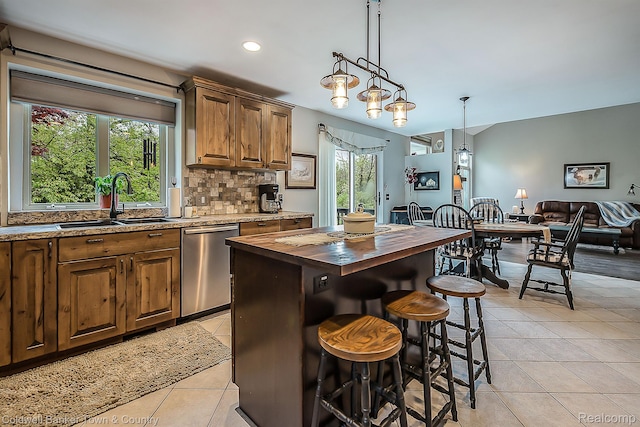 1355 Maxfield Rd, Brighton, MI 48114 - kitchen with butcher block countertops, dishwasher, light tile patterned floors, backsplash, and open floor plan