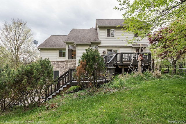 1355 Maxfield Rd, Brighton, MI 48114 - back of house with a wooden deck, a lawn, stairs, stone siding, and roof with shingles