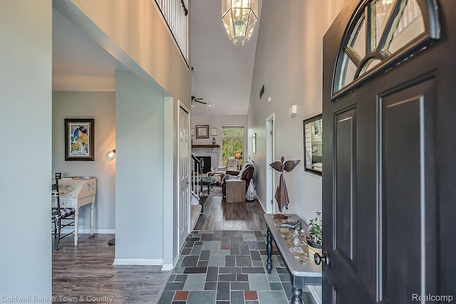 1355 Maxfield Rd, Brighton, MI 48114 - foyer featuring a high ceiling, dark wood-type flooring, and a brick fireplace
