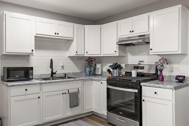 645 Amity Ave, Muskegon, MI 49442 - kitchen featuring gas range, under cabinet range hood, black microwave, and white cabinetry