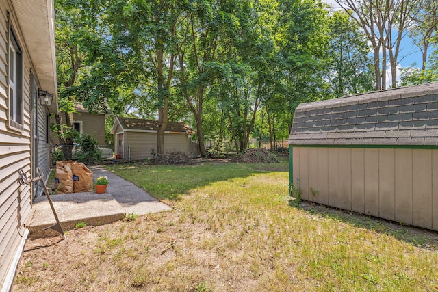 645 Amity Ave, Muskegon, MI 49442 - view of yard featuring a storage shed and a patio