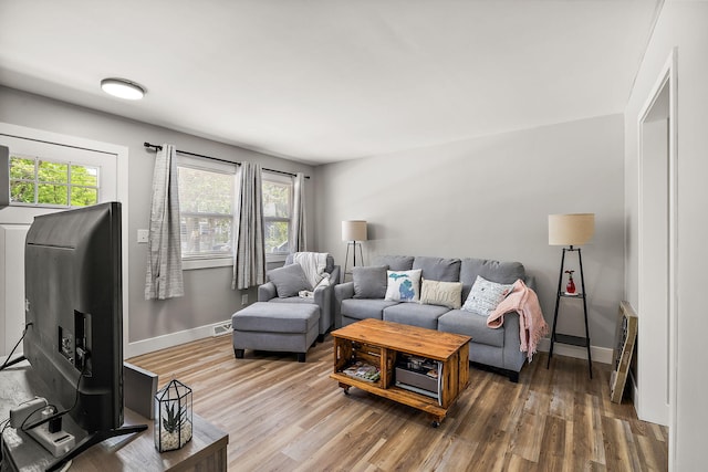 645 Amity Ave, Muskegon, MI 49442 - living area featuring wood finished floors and heating unit