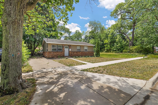 645 Amity Ave, Muskegon, MI 49442 - view of front of house featuring brick siding, driveway, and a front yard
