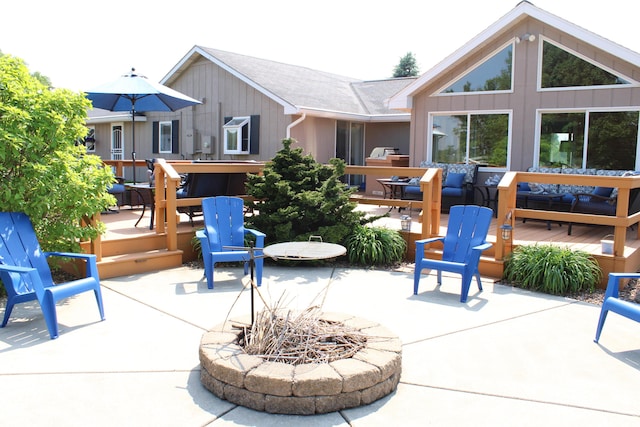 7680 S Warner Ave, Fremont, MI 49412 - view of patio featuring a fire pit and a deck