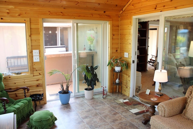 7680 S Warner Ave, Fremont, MI 49412 - sitting room with wooden walls, vaulted ceiling, and stone finish flooring