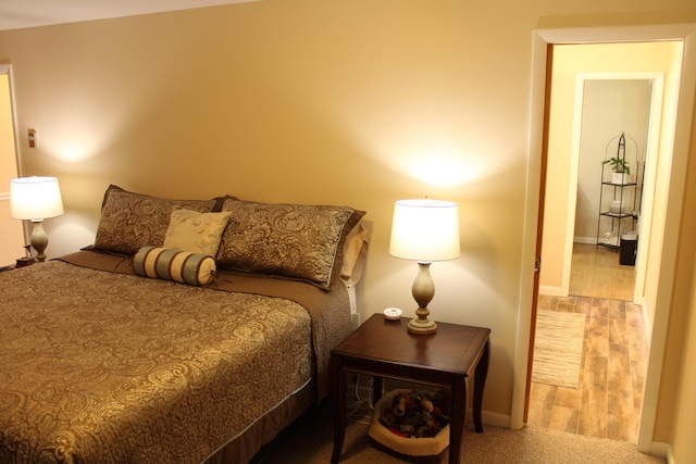 7680 S Warner Ave, Fremont, MI 49412 - bedroom with wood finished floors and baseboards