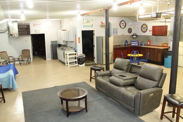 7680 S Warner Ave, Fremont, MI 49412 - living area with a heating unit, bar area, and finished concrete floors