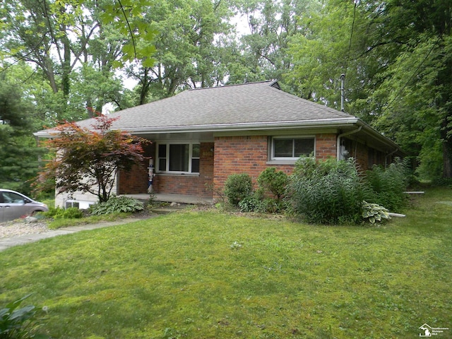 6864 Hazeldell Dr, Temperance, MI 48182 - view of front of property featuring brick siding, a front yard, and roof with shingles