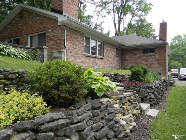6864 Hazeldell Dr, Temperance, MI 48182 - view of side of home featuring a chimney and brick siding